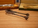 a pair of tonges sitting on a table next to a case