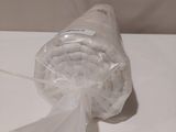 a bag of toilet paper and a roll of toilet paper on a table