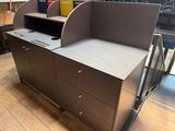a desk that has a shelf on top of it