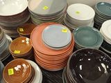 a lot of plates and bowls on the table