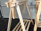 two wooden chairs sitting next to each other on the floor