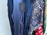 a lot of clothes hanging on a rack in a room