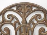 a decorative iron wall hanging on a white wall
