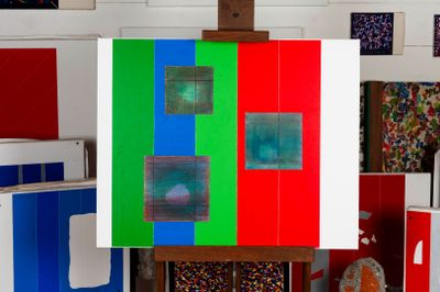 a picture of an easel with a painting on it in a room