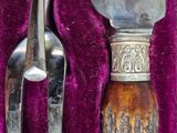 a silver spoon and a silver spoon on a purple cloth