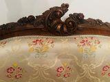 a couch that has a floral pattern on the back of it