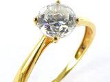 a close up of a diamond ring on a white surface