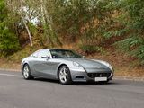 a silver sports car that is driving down the road