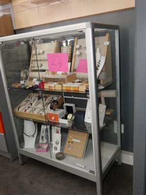 a display case with many items in it in a room