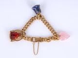 a close up of a triangle shaped brooch with a chain around it