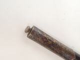 a metal object that is on a white surface