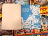 a lot of comic books on the table together