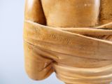 a wooden statue of a woman wrapped in a wrap