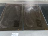 two metal trays that are on display in a glass case