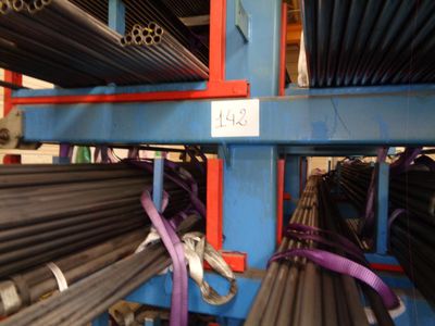 a rack of pipes and tubes in a warehouse