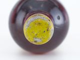 a close up of a wine bottle with a yellow cap