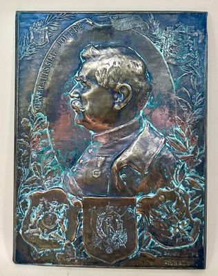an image of a bronze plaque of a man in a suit and tie