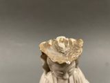 an image of a statue of a woman with a shell on her head