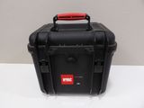 a close up of a black case with a red handle on a table