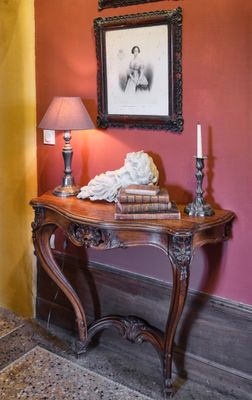 une table avec une lampe et un tableau accroché au mur