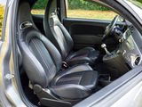 the interior of a car with black leather seats and red stitching