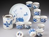 a lot of blue and white cups and saucers on the table