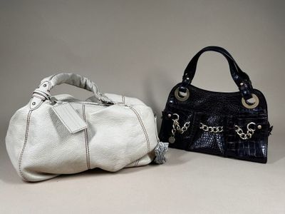 pair of black and white purses with tags on them
