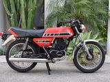 a red and black motorcycle parked in front of a building