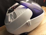a white and purple vacuum sitting on top of a wooden table