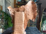a clay sculpture of a horse on a table in a room