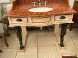 a bathroom with a sink and a mirror on the wall