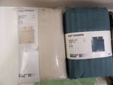 three sheets of bedding in a box on a shelf