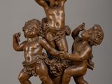 bronze statue of a group of children playing with a ball