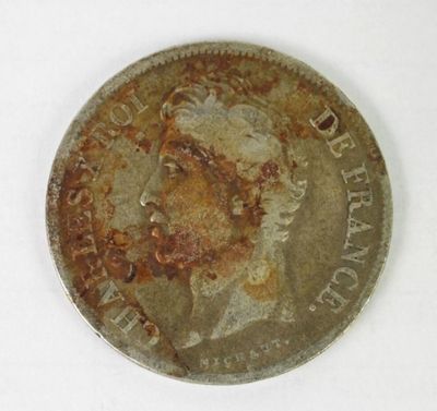 an old silver coin with a picture of a man ' s face on it