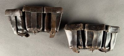 pair of antique silver plated belt buckles on a gray surface