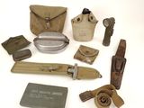 an assortment of military items including a knife, belt and other items