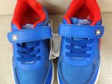a pair of blue and red shoes on a couch