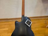 an electric guitar sits on a stand in a room