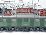 a model train on a table with a drawing in the background