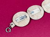 an image of a close up of a bracelet on a red surface