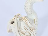 porcelain figurine of a white bird with a long neck and a long tail
