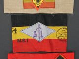 three different types of military patches on a black surface