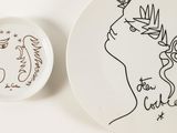 a plate with a drawing of a woman and a plate with a horse on it