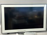 a flat screen tv sitting on a table with a remote