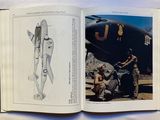 a book with a drawing of a man and a woman in front of an airplane