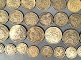 some of the coins have been placed on the table for display