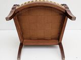 an image of a wooden chair with a brown seat on a white surface