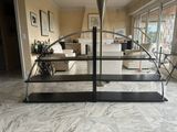 a glass shelf in the middle of a living room