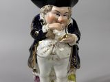 a figurine of a man with a hat on