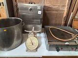 a large pot on a table with a scale on it